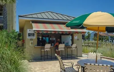 a restaurant with a table and an umbrella at Grand Panama 1406 in Panama City Beach