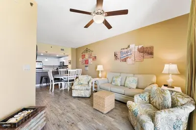 a living room with a couch and a ceiling fan at Grand Panama 1408 in Panama City Beach