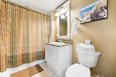 a bathroom with a toilet and a sink at Grand Panama 1408 in Panama City Beach
