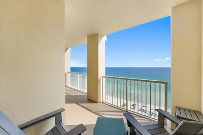 a balcony with chairs and a view of the ocean at Grand Panama 1408 in Panama City Beach