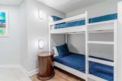a bedroom with two bunk beds with a blue mattress at Grand Panama 1508 in Panama City Beach