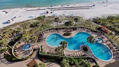 an overhead view of a swimming pool next to a beach at Grand Panama 1801 in Panama City Beach