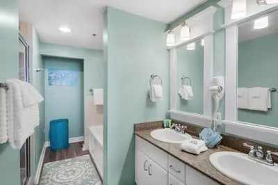 a bathroom with two sinks and a large mirror at Grand Panama 1806 in Panama City Beach