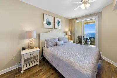 a bedroom with a bed and a view of the ocean at Grand Panama 2004 in Panama City Beach