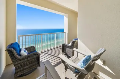 a balcony with two chairs and a view of the ocean at Grand Panama 2004 in Panama City Beach