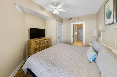 a bedroom with a bed and a flat screen tv at Grand Panama 2004 in Panama City Beach