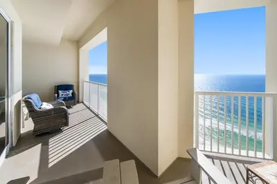 a balcony with a chair and a view of the ocean at Grand Panama 2004 in Panama City Beach