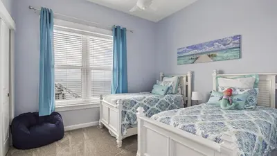 a bedroom with two beds and a window at Grand Panama 2009 in Panama City Beach