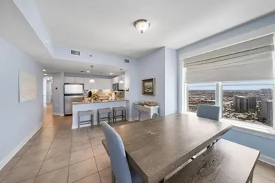 a dining room and kitchen with a table and chairs at Grand Panama 2009 in Panama City Beach