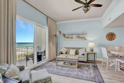 a living room with a couch and a table at Sterling Breeze 202 in Panama City Beach