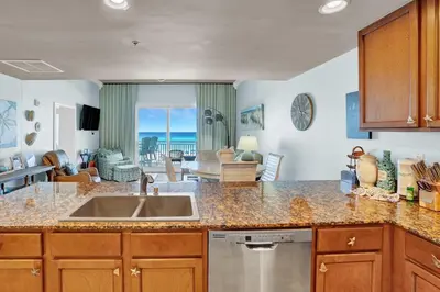 a kitchen with a sink and a view of the ocean at Sterling Breeze 202 in Panama City Beach