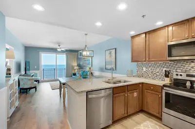 a kitchen with a sink and a stove top oven at Sterling Breeze 401 in Panama City Beach