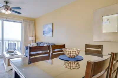 a living room with a table and a couch at Sterling Breeze 406 in Panama City Beach