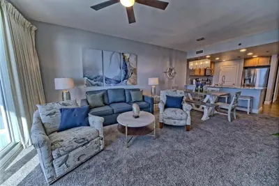 a living room with a couch and a table at Sterling Breeze 1506 in Panama City Beach