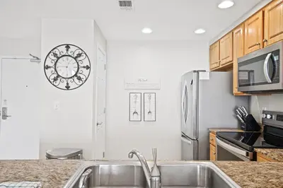 a kitchen with a sink and a refrigerator at Splash 707E in Panama City Beach