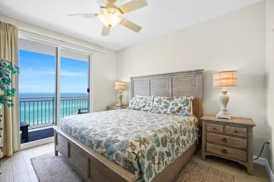 a bedroom with a bed with a view of the ocean at Splash 707E in Panama City Beach