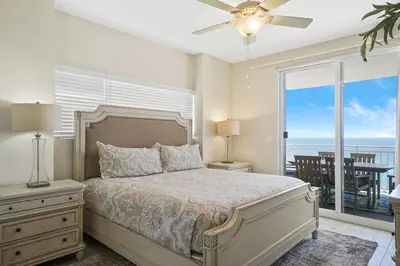 a bedroom with a bed with a view of the ocean at Splash 707E in Panama City Beach