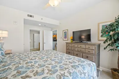 a bedroom with a bed and a flat screen tv at Splash 707E in Panama City Beach