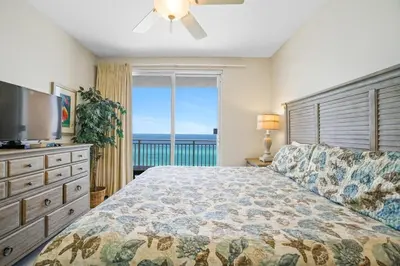 a bedroom with a bed and a large window at Splash 707E in Panama City Beach