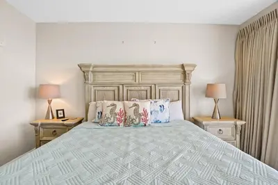 a bedroom with a large bed with two night stands at Splash 903W in Panama City Beach