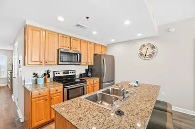 a kitchen with a sink and a stove top oven at Splash 903W in Panama City Beach