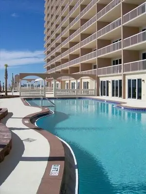 a swimming pool in front of a large building at Sunrise Beach 801 in Panama City Beach