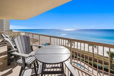 a table and chairs on a balcony with the beach at Sunrise Beach 801 in Panama City Beach