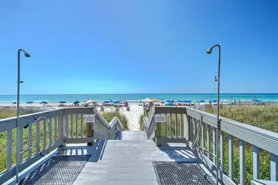 a stairway to the beach with the ocean in the background at Sunrise 1611 in Panama City Beach