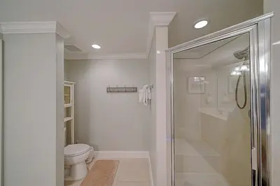 a white bathroom with a toilet and a shower at Sunrise 2011 in Panama City Beach