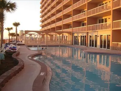 a hotel with a swimming pool in front of a building at Sunrise 2401 in Panama City Beach