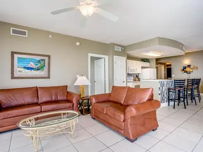 a living room with a couch and a table at Sunrise 2401 in Panama City Beach