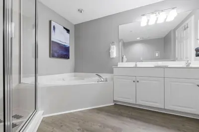 a white bathroom with a tub and a sink at Gulf views, beachfront, Majestic Beach Resort in Panama City Beach