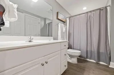 a white bathroom with a sink and a toilet at Gulf views, beachfront, Majestic Beach Resort in Panama City Beach
