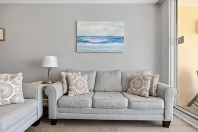 a living room with a couch and a painting on the wall at Gulf views, beachfront, Majestic Beach Resort in Panama City Beach