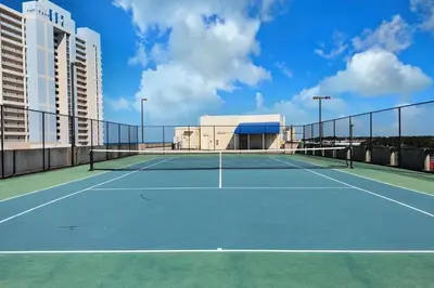 a tennis court in front of a building at Gulf views, beachfront, Majestic Beach Resort in Panama City Beach