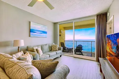 a living room with a couch and a view of the ocean at Gulf views, beachfront, Majestic Beach Resort in Panama City Beach