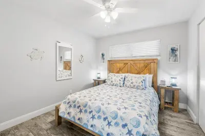 a bedroom with a bed and a ceiling fan at Aquavista E406 in Panama City Beach