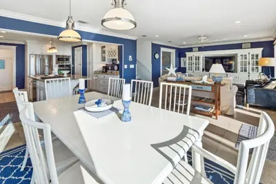 a kitchen and dining room with a white table and chairs at Spring Break Promo! Gulf Front Home with Private Beach Access with Bikes! in Inlet Beach
