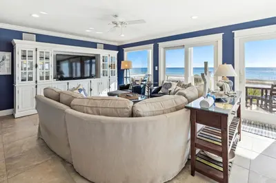 a living room with a large couch and a television at Spring Break Promo! Gulf Front Home with Private Beach Access with Bikes! in Inlet Beach