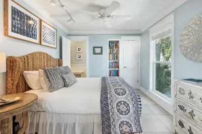 a bedroom with a bed and a table and a window at Spring Break Promo! Gulf Front Home with Private Beach Access with Bikes! in Inlet Beach