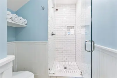 a shower with a glass door in a bathroom at Spring Break Promo! Gulf Front Home with Private Beach Access with Bikes! in Inlet Beach
