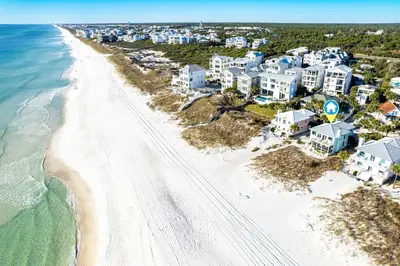 an aerial view of a beach with houses and the ocean at Spring Break Promo! Gulf Front Home with Private Beach Access with Bikes! in Inlet Beach