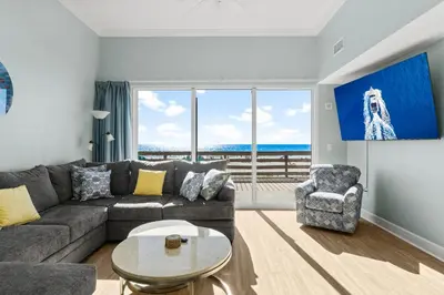 a living room with a couch and a table at Tidewater Resort! Ground Floor! Free Beach Chairs! by Dolce Vita Getaways PCB in Panama City Beach