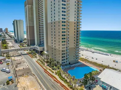 an aerial view of a building and the beach at Tidewater Resort! Ground Floor! Free Beach Chairs! by Dolce Vita Getaways PCB in Panama City Beach