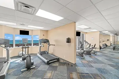 a fitness room with treadmills and elliptical machines at Tidewater Resort! Ground Floor! Free Beach Chairs! by Dolce Vita Getaways PCB in Panama City Beach