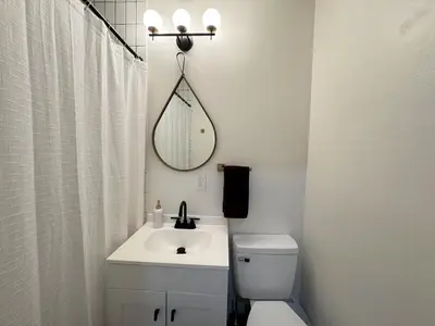 a bathroom with a sink and a toilet and a mirror at Dreami Stays Panama City - 2BR Retreat Near Downtown, Beaches, & Hot Spots in Panama City