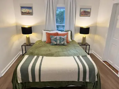 a bedroom with a large bed with two lamps at Dreami Stays Panama City - 2BR Retreat Near Downtown, Beaches, & Hot Spots in Panama City