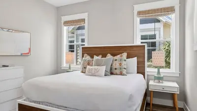a bedroom with a large white bed with pillows at Arcade Bar Prominence Resort Pool and Gym Access Close to Beach Sea Happy in Watersound Beach