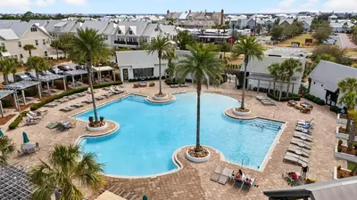 an overhead view of a large swimming pool with palm trees at Arcade Bar Prominence Resort Pool and Gym Access Close to Beach Sea Happy in Watersound Beach
