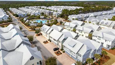 an aerial view of a village with white houses at Arcade Bar Prominence Resort Pool and Gym Access Close to Beach Sea Happy in Watersound Beach